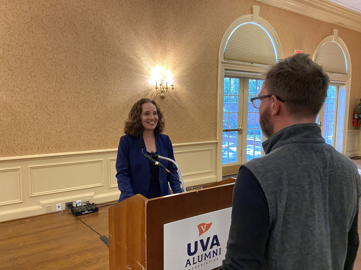 Law School Dean Risa Goluboff stands behind a podium while chatting with an RFA member after lecture.