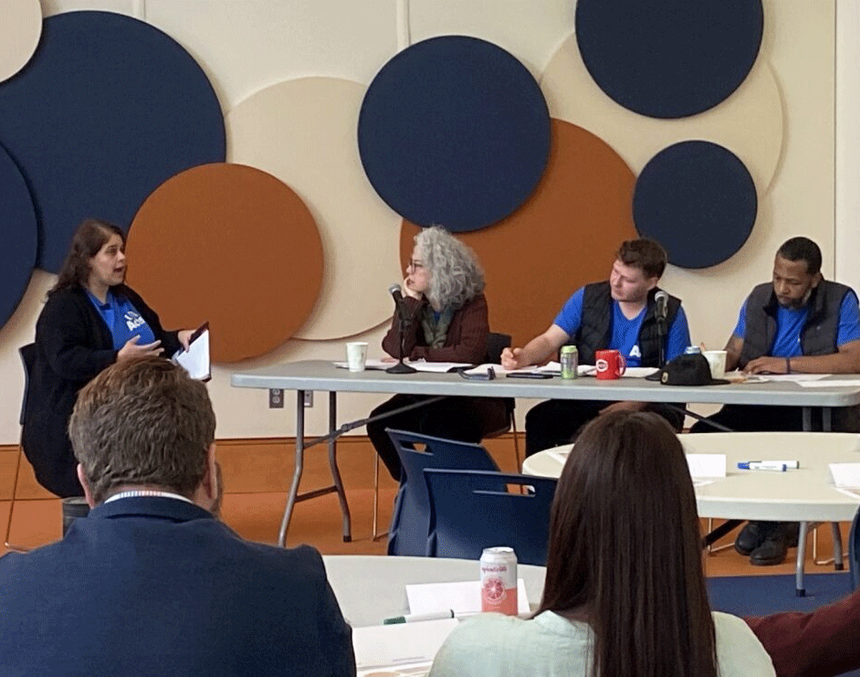 Woman speaking to a group of UVA Acts panelists.