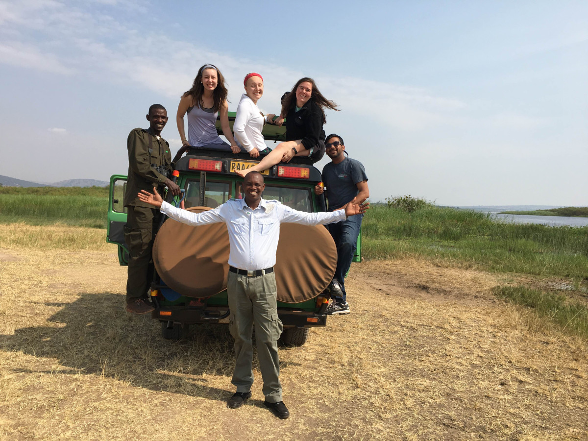 Group of people, some on a Jeep, in Rwanda.