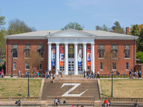Garrett Hall with banners hanging between the columns and students walking by on the sidewalk.