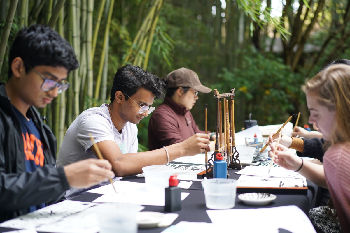 Students brush painting by bamboo