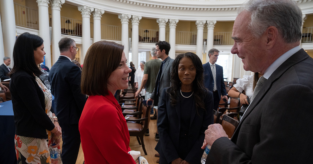 A diverse group of people mingling in the Rotunda's Dome Room.