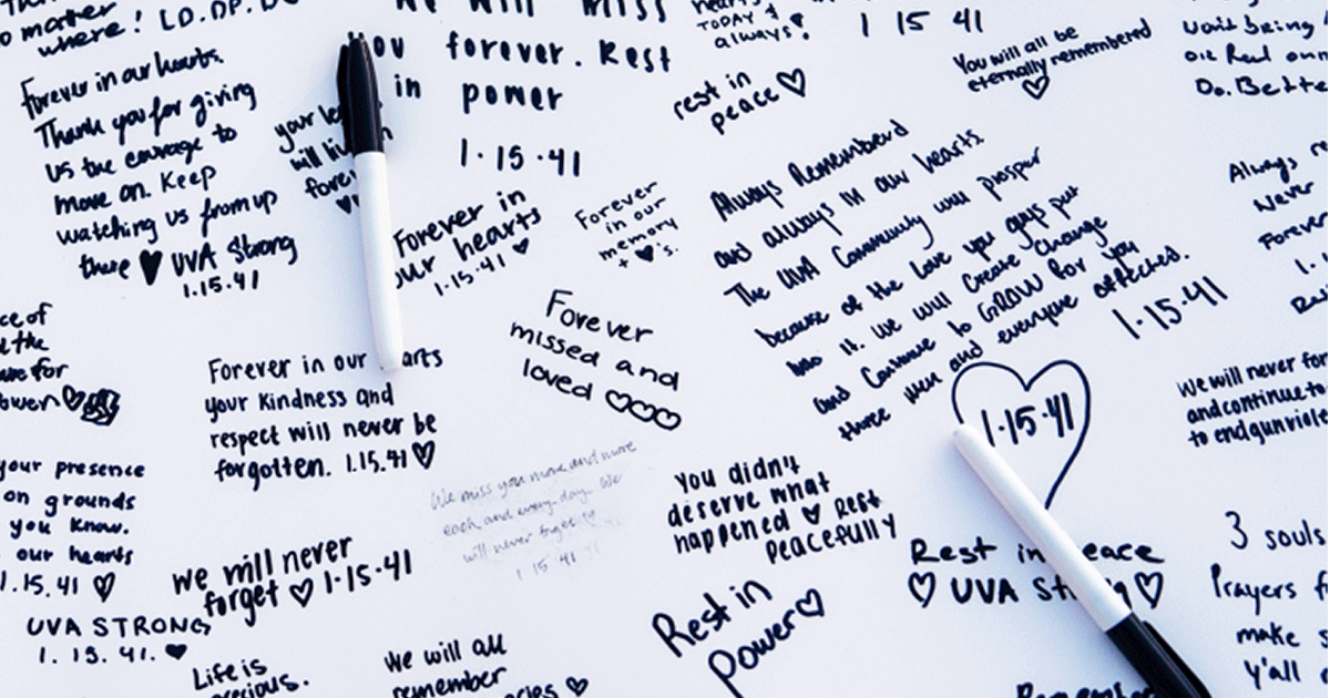 Two ink markers on a poster board filled with handwritten messages.
