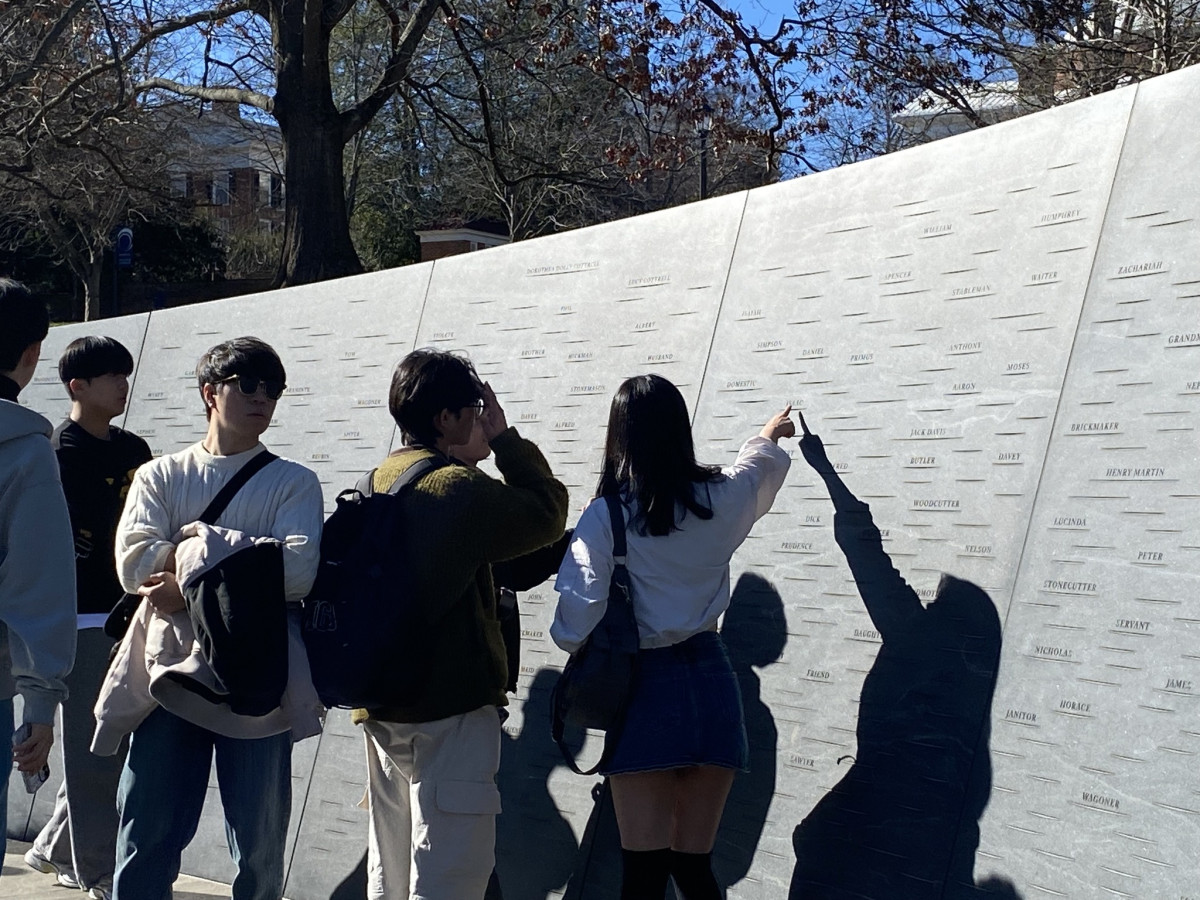Students visiting the enslaved workers memorial