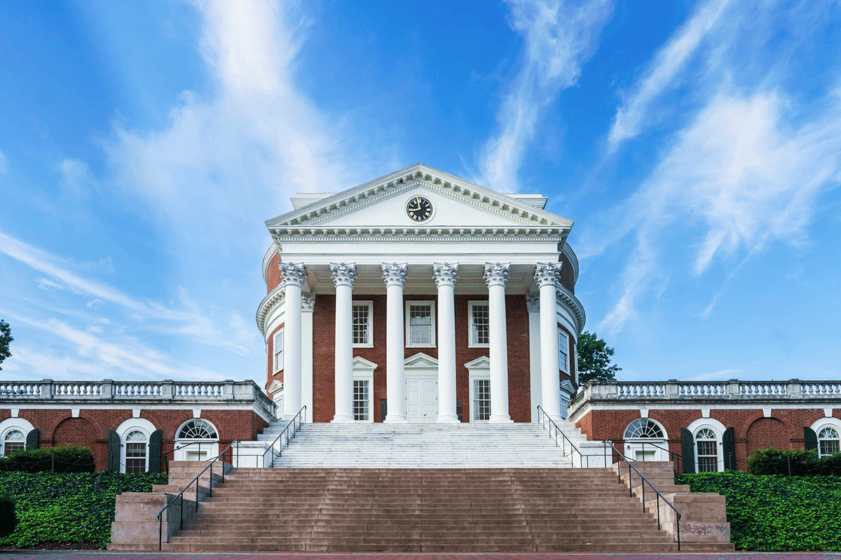 The columned front facade of the UVA Rotunda with bright blue sky in background
