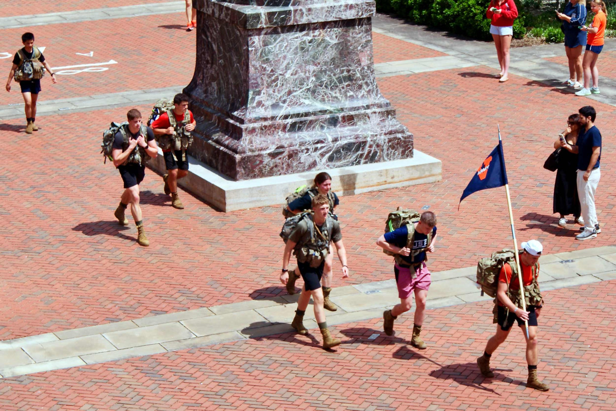 ROTC cadets marching across the steps of the Rotunda beneath the Thomas Jefferson statue.