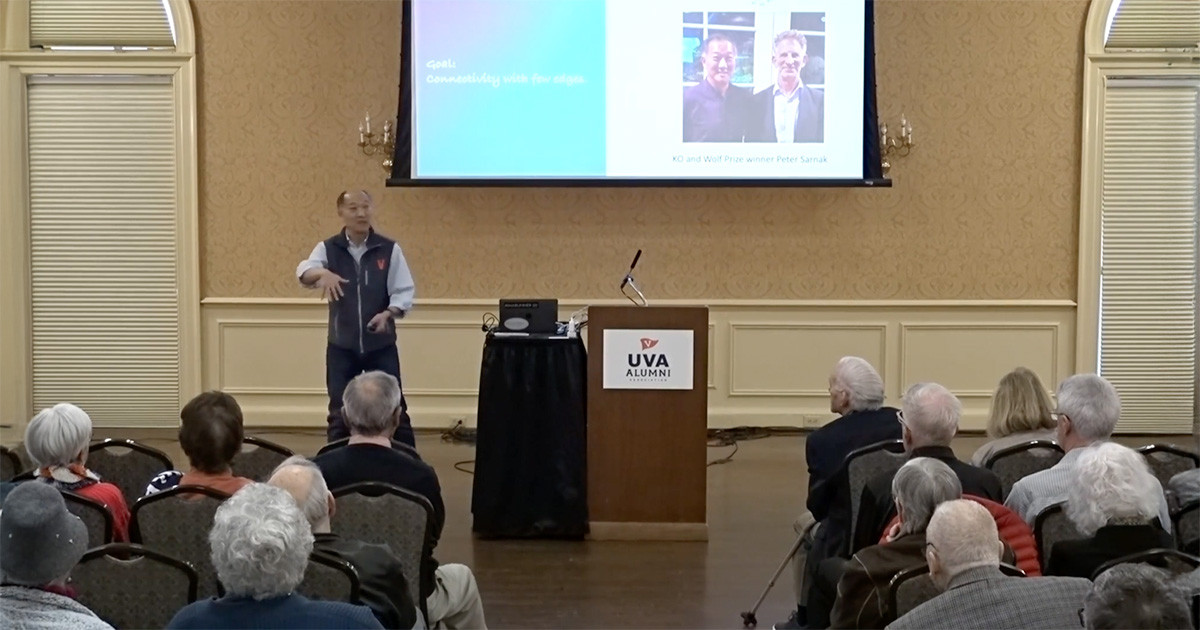 Professor Ken Ono stands at the front of an audience while speaking.