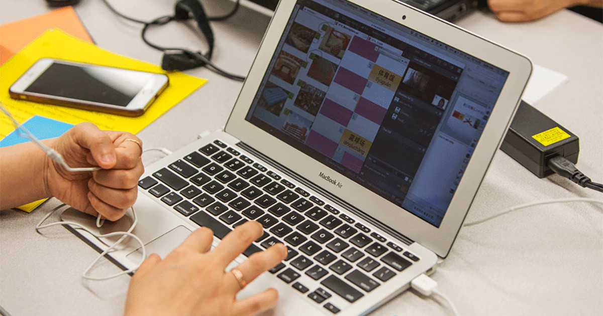 An open laptop with hands resting on keyboard.