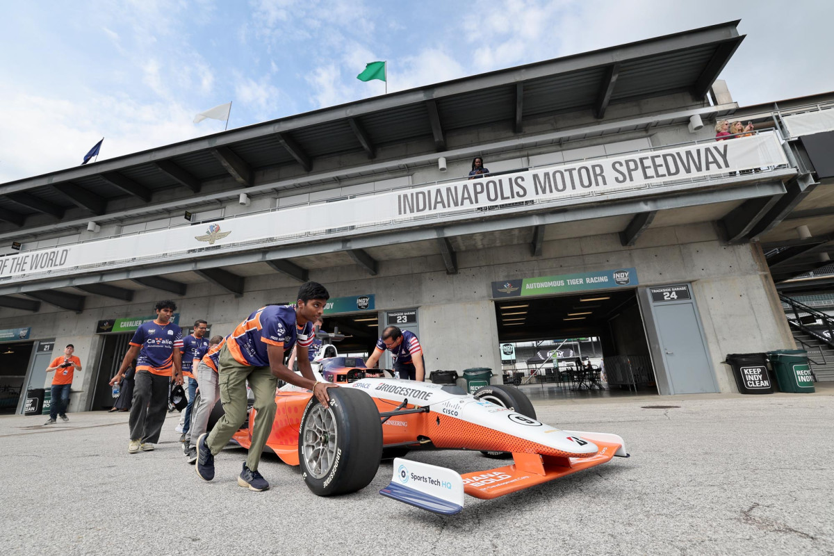 The Cavalier Autonomous Racing Team pushes their autonomous racecar out to the track at Indianapolis Motor Speedway.