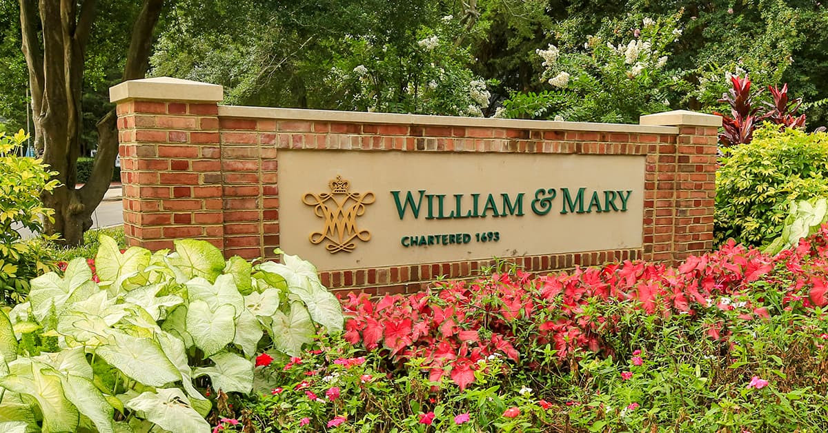 Brick entry wall with the name William and Mary in the College's signature font and color.